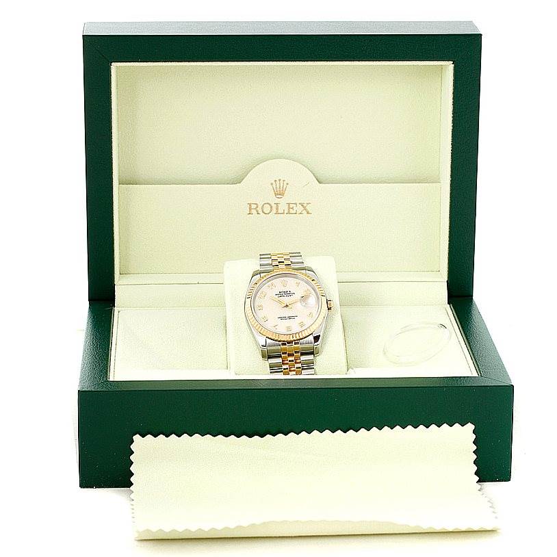 The Rolex Datejust 116233 Men's Stainless Steel Beige Dial 116233 Men's Stainless Steel Beige Dial watch is shown from the front inside its open green and beige box, with a cleaning cloth placed in front.