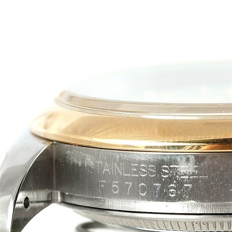 This image shows a close-up of the side casing of a Rolex Datejust 116203 Men's Stainless Steel Mother of Pearl Dial 116203 Men's Stainless Steel Mother of Pearl Dial watch, displaying its serial number and stainless steel material.