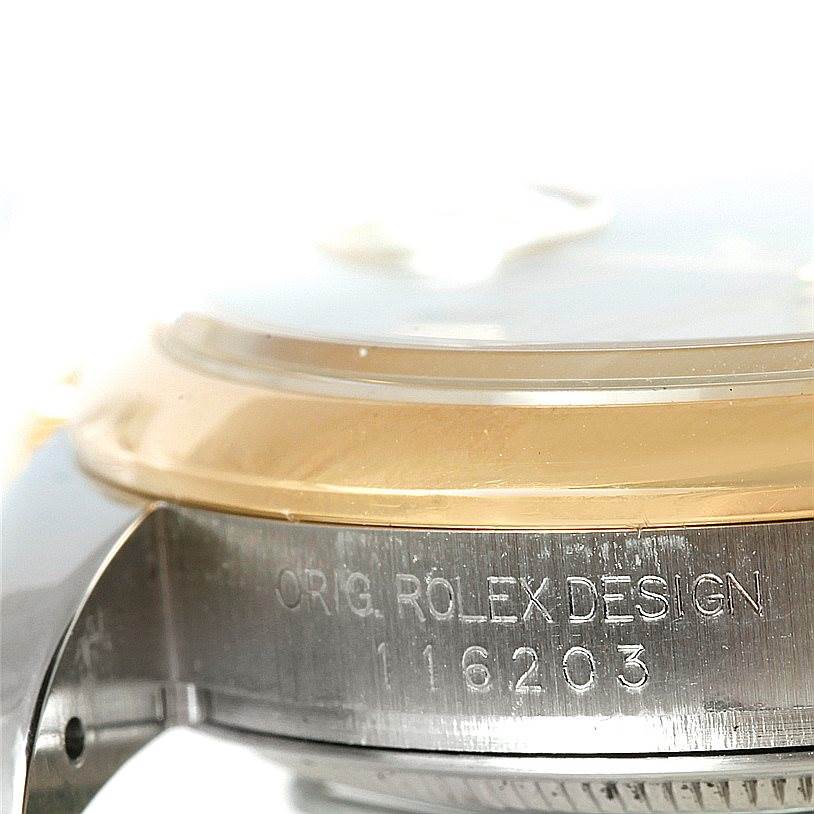 The image shows a close-up side view of the case with engraved text and the edge of the bezel of a Rolex Datejust 116203 Men's Stainless Steel Mother of Pearl Dial 116203 Men's Stainless Steel Mother of Pearl Dial watch.