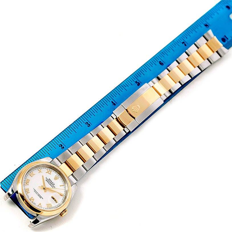 This image shows a Rolex Datejust 116203 Men's Stainless Steel Mother of Pearl Dial 116203 Men's Stainless Steel Mother of Pearl Dial watch laying flat, with a ruler alongside to measure its length.