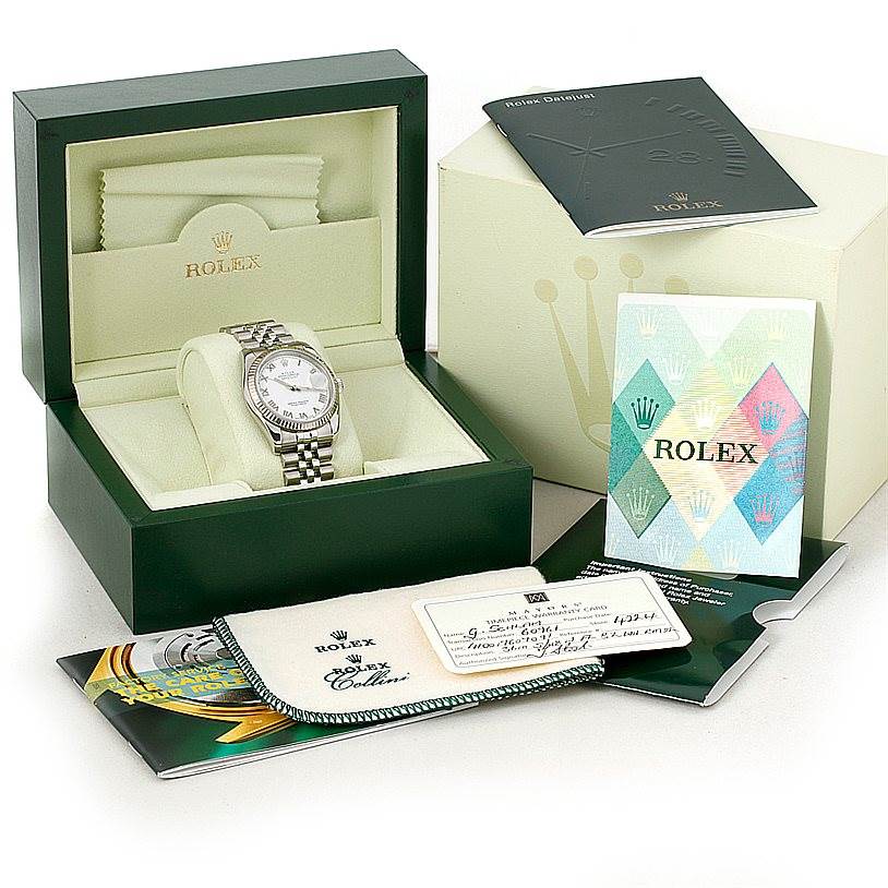 The Rolex Datejust 116234 Men
s Stainless Steel White Dial 116234 Men
s Stainless Steel White Dial watch is displayed in its open green box, accompanied by booklets and warranty cards outside.