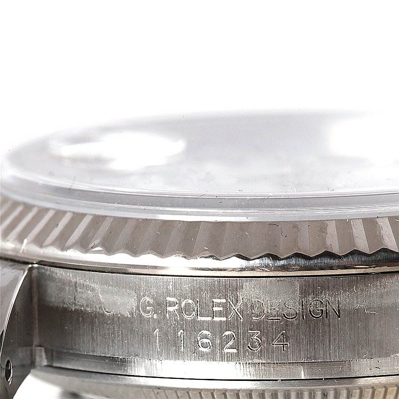 The image shows a close-up of the side view, bezel, and part of the case with the serial number of a Rolex Datejust 116234 Men
s Stainless Steel White Dial 116234 Men
s Stainless Steel White Dial watch.