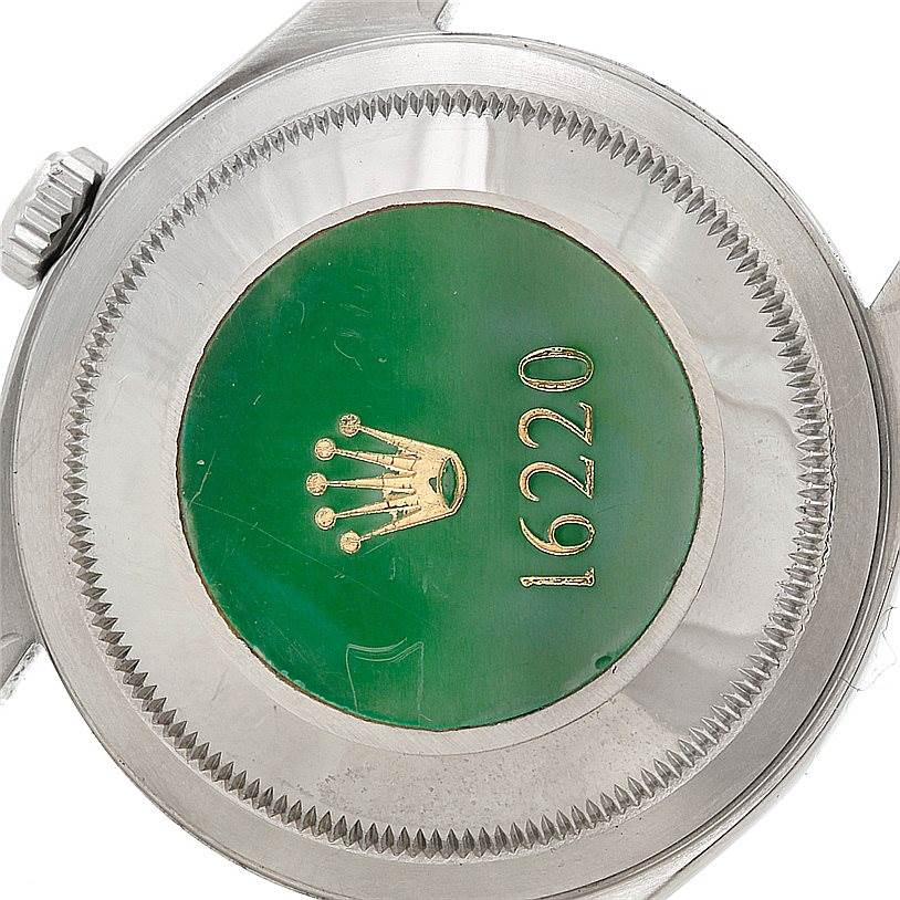 This image shows the green hologram sticker and caseback of a Rolex Datejust 16220 Men
s Stainless Steel Black Dial 16220 Men
s Stainless Steel Black Dial model 16220 watch taken from its rear.