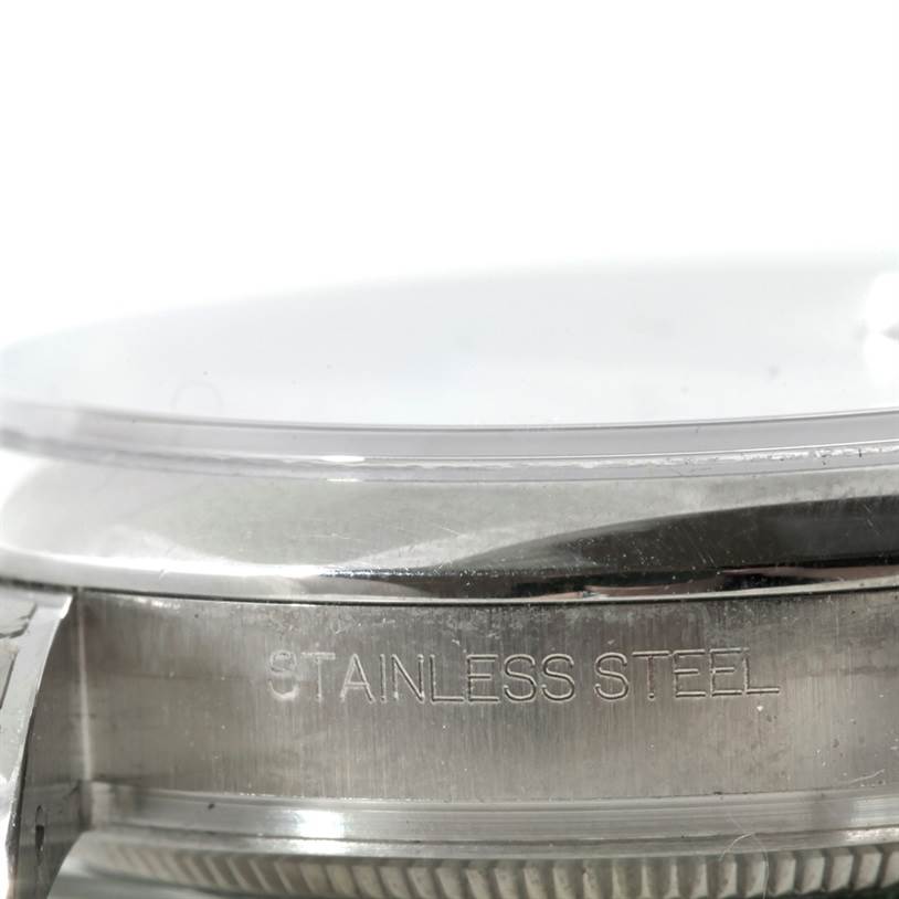 This image shows a close-up of the side profile of a Rolex Datejust 116200 Men
s Stainless Steel White Dial 116200 Men
s Stainless Steel White Dial
s stainless steel case.