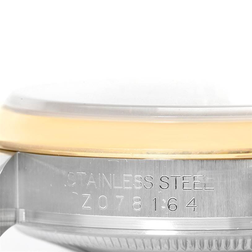 The image shows a close-up side view of the serial number and "STAINLESS STEEL" engraving on a Rolex Datejust 116203 Men's Stainless Steel Silver Dial 116203 Men's Stainless Steel Silver Dial watch.