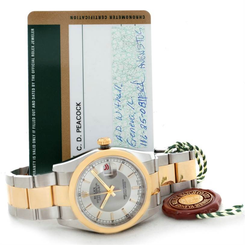 The image shows a Rolex Datejust 116203 Men's Stainless Steel Silver Dial 116203 Men's Stainless Steel Silver Dial watch at a slight side angle with its chronometer certification card and a green and gold tag.