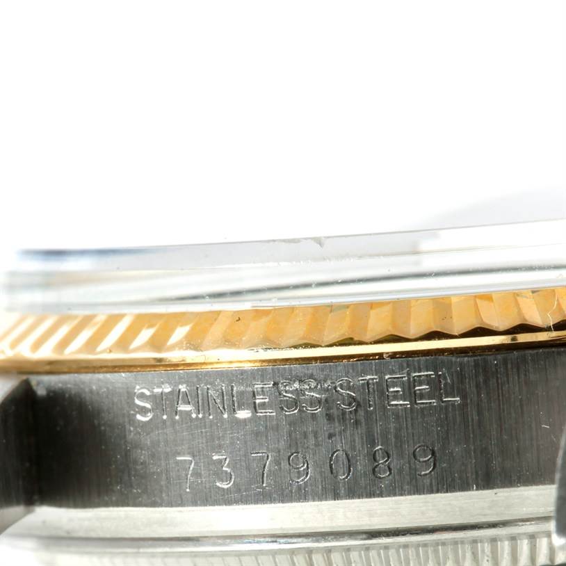 The image shows a close-up of the Rolex Datejust 16013 Men's Stainless Steel Champagne Dial 16013 Men's Stainless Steel Champagne Dial watch, highlighting the side case and stainless steel engraving.