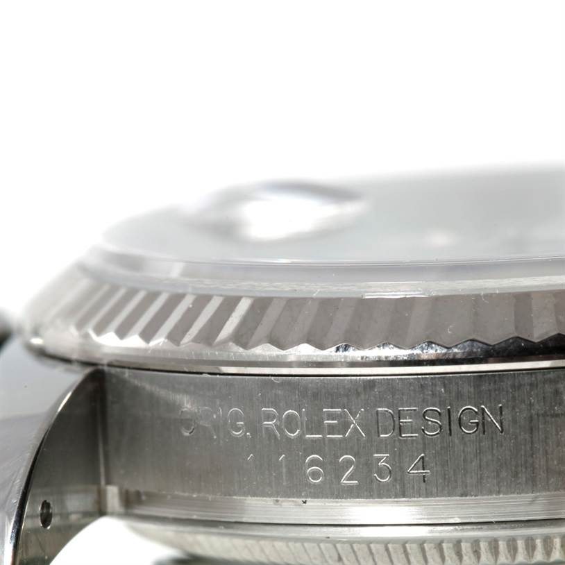 The image shows a close-up of the side and bezel of a Rolex Datejust 116234 Men
s Stainless Steel White Dial 116234 Men
s Stainless Steel White Dial watch with the model number and "ORIG. ROLEX DESIGN" engraved.