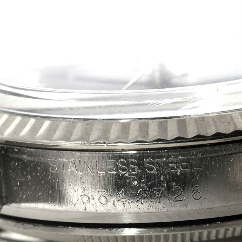 This close-up image shows the side of a Rolex Datejust 16014 Men's Stainless Steel Blue Dial 16014 Men's Stainless Steel Blue Dial, highlighting the stainless steel case and part of the bezel.