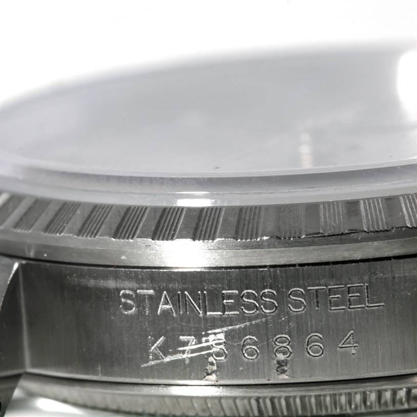 This image shows a close-up of the side view of a Rolex Datejust 16220 Men's Stainless Steel Silver Dial 16220 Men's Stainless Steel Silver Dial watch, highlighting its stainless steel case and model number engraving.