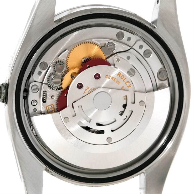 This is a close-up shot of the movement assembly of the Rolex Datejust 116200 Men's Stainless Steel Blue Dial 116200 Men's Stainless Steel Blue Dial model, showing gears and the rotor.