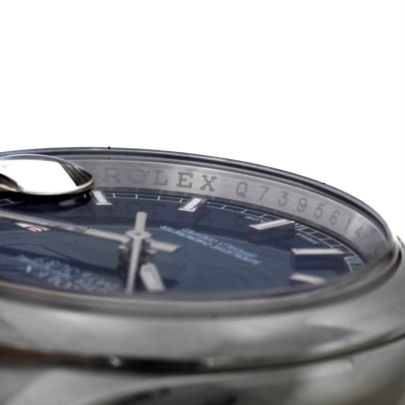 The image shows a close-up of the Rolex Datejust 116200 Men's Stainless Steel Blue Dial 116200 Men's Stainless Steel Blue Dial watch from an angle, highlighting its bezel and part of the dial.