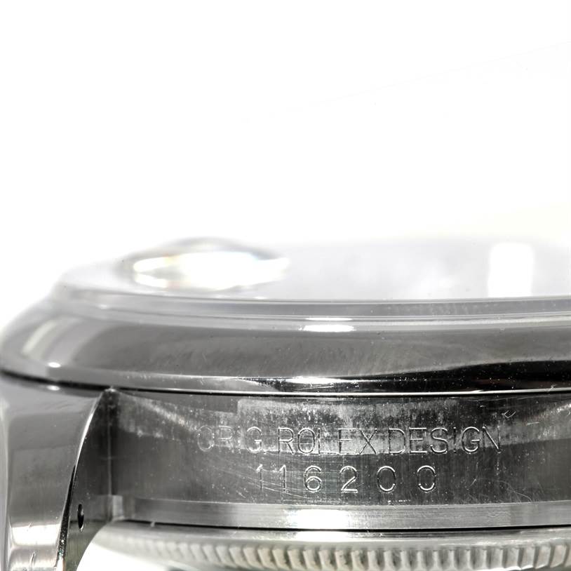 The image shows a close-up of the side of the case and part of the bezel of the Rolex Datejust 116200 Men's Stainless Steel Blue Dial 116200 Men's Stainless Steel Blue Dial watch.