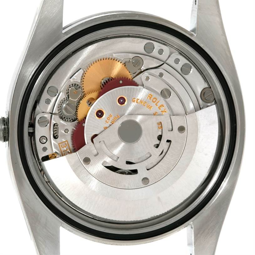 The image shows the back view of the Rolex Datejust 116200 Men
s Stainless Steel Black Dial 116200 Men
s Stainless Steel Black Dial watch, revealing its intricate internal mechanism.