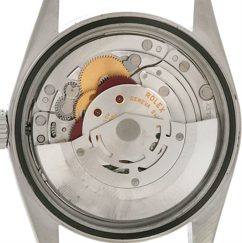 The image shows the back side of a Rolex Datejust 16200 Men's Stainless Steel Black Dial 16200 Men's Stainless Steel Black Dial model, revealing its intricate inner movement and gears.