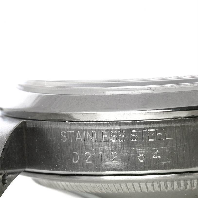 The image shows a close-up of the side of a Rolex Datejust 16200 Men's Stainless Steel Black Dial 16200 Men's Stainless Steel Black Dial watch case, highlighting the stainless steel material and serial number.