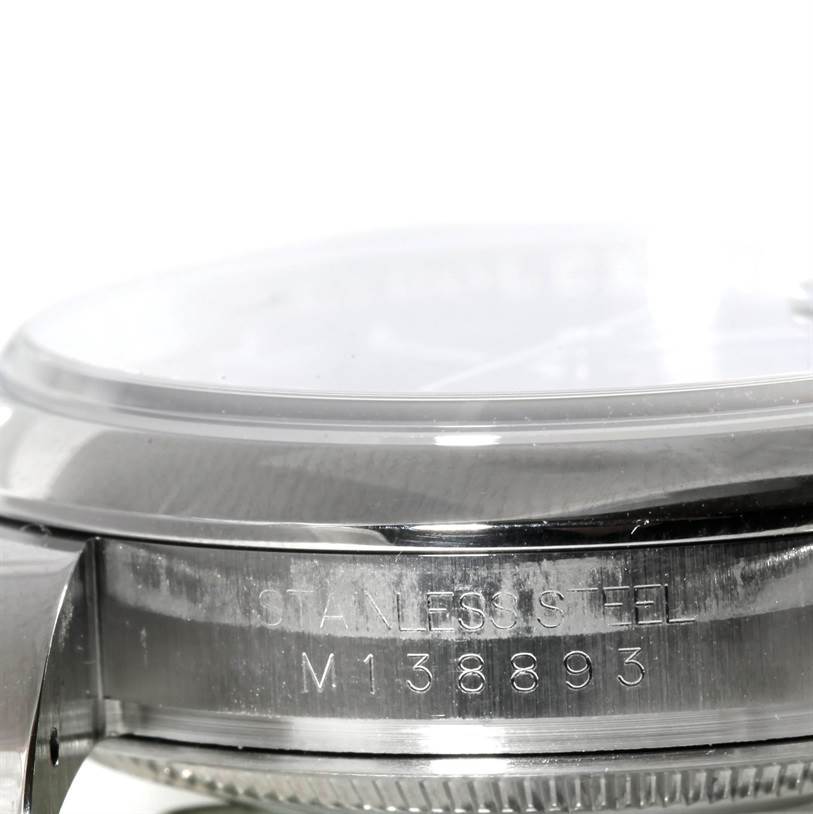 This is a close-up shot of the side case of a Rolex Datejust 116200 Men
s Stainless Steel Black Dial 116200 Men
s Stainless Steel Black Dial, showing the engraved serial number and "STAINLESS STEEL."