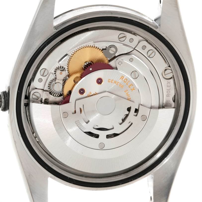 The image shows the back view of a Rolex Datejust 116200 Men
s Stainless Steel Black Dial 116200 Men
s Stainless Steel Black Dial, revealing its mechanical movement components.