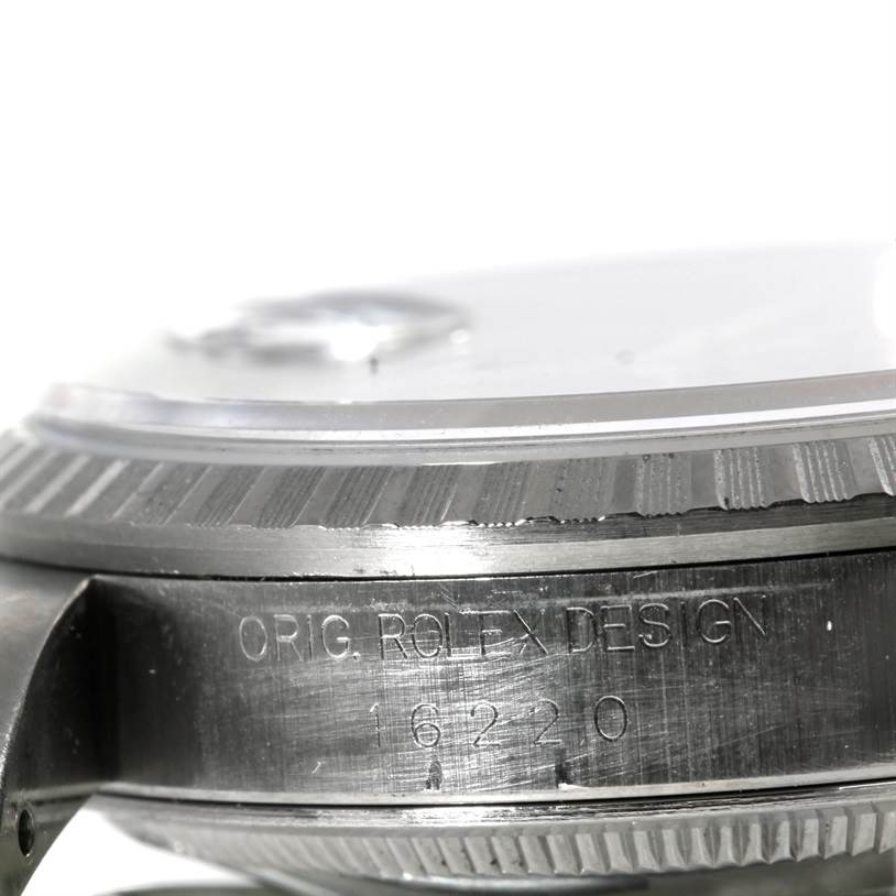 The image shows a side view of the casing and part of the bezel of a Rolex Datejust 16220 Men's Stainless Steel Blue Dial 16220 Men's Stainless Steel Blue Dial model, engraved with "ORIG. ROLEX DESIGN 16220".