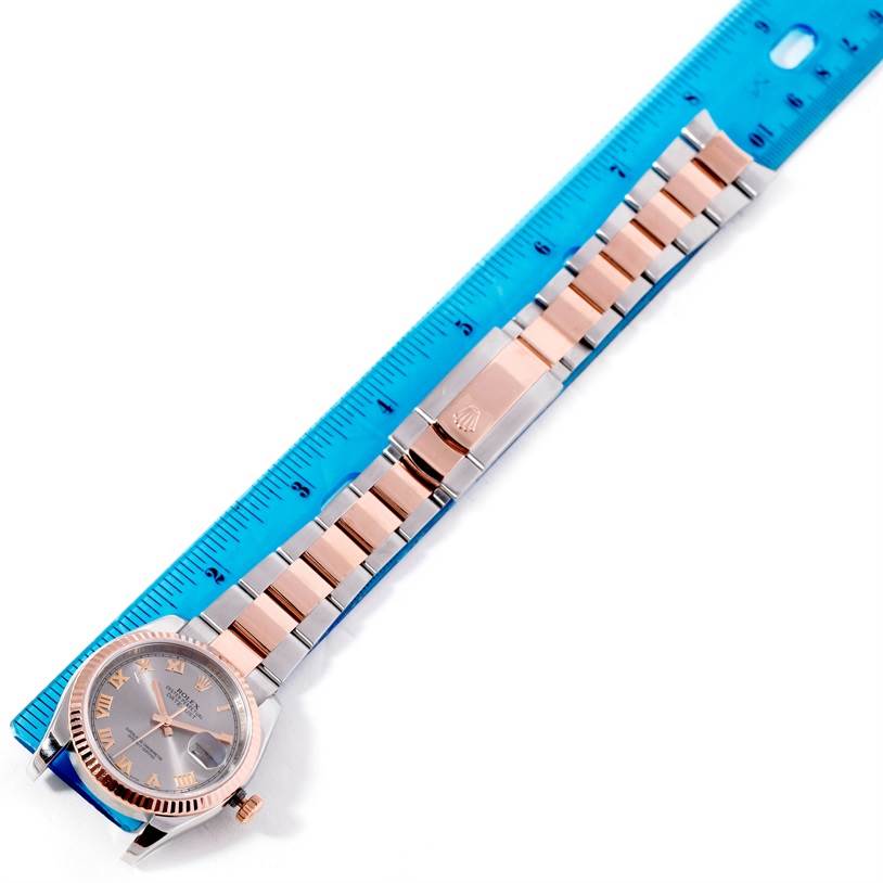 The image shows a top-down view of a Rolex Datejust 116231 Men's Steel and Gold (two tone) Pink Dial 116231 Men's Steel and Gold (two tone) Pink Dial watch, with its face, bezel, crown, and metal bracelet laid out next to a ruler.