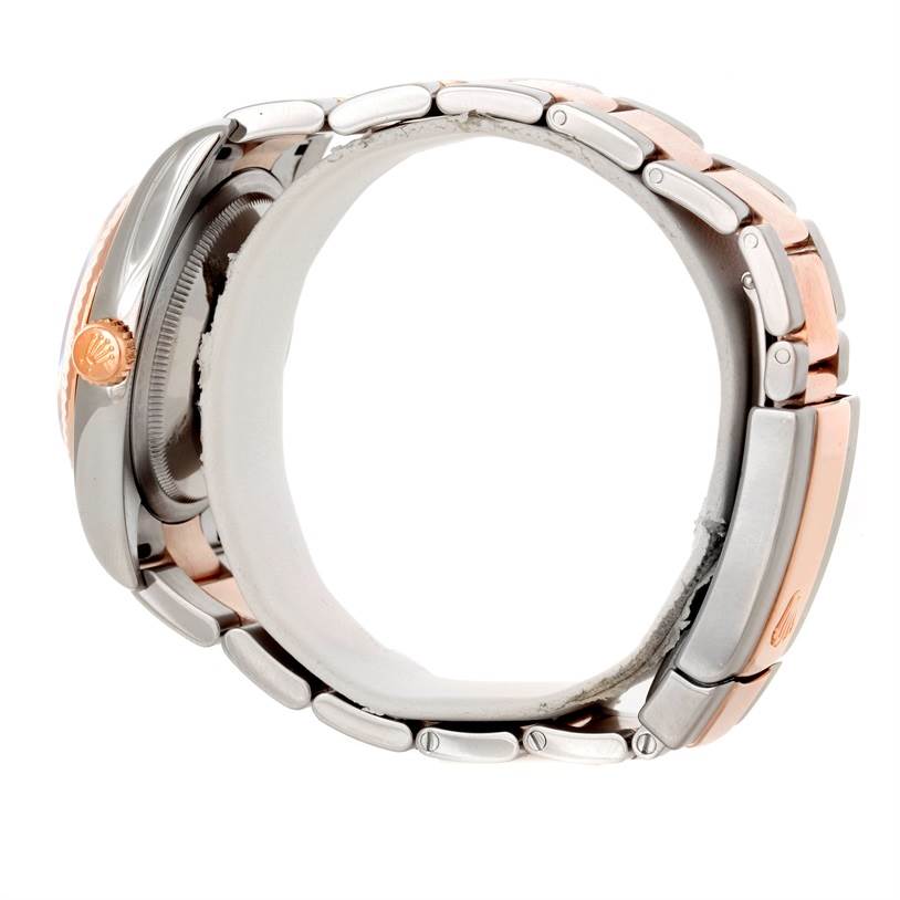 The image shows the side of a Rolex Datejust 116231 Men's Steel and Gold (two tone) Pink Dial 116231 Men's Steel and Gold (two tone) Pink Dial watch, highlighting its crown and bracelet links.