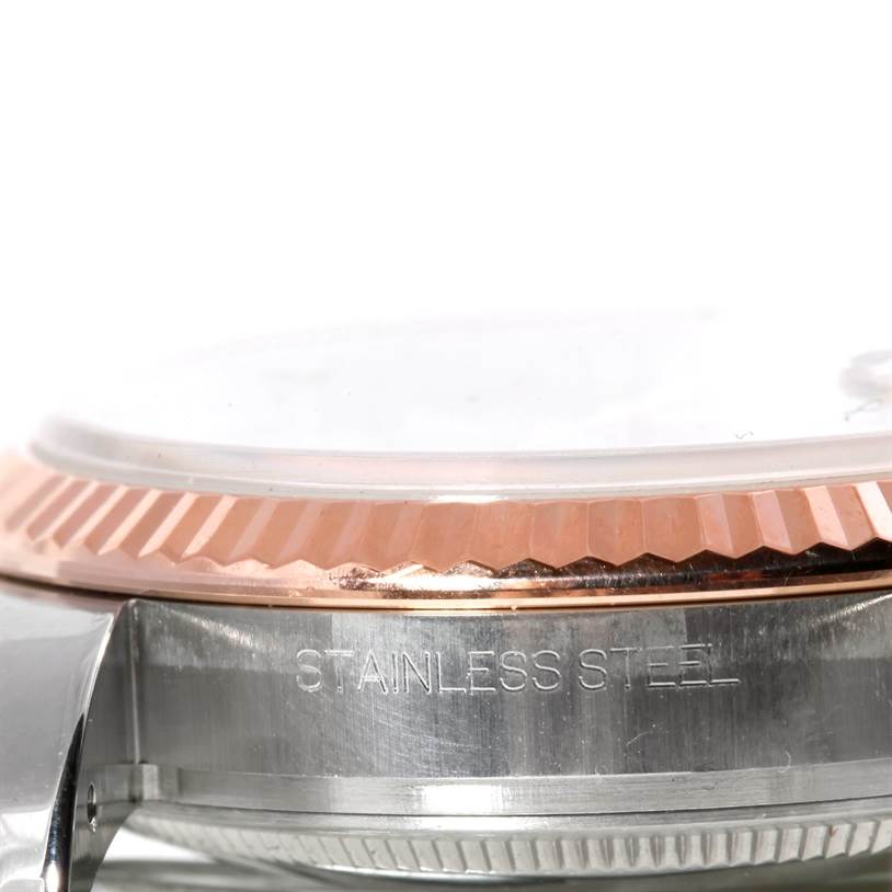 This image shows a close-up side view of the bezel and case of a Rolex Datejust 116231 Men's Steel and Gold (two tone) Pink Dial 116231 Men's Steel and Gold (two tone) Pink Dial watch, highlighting its stainless steel construction.