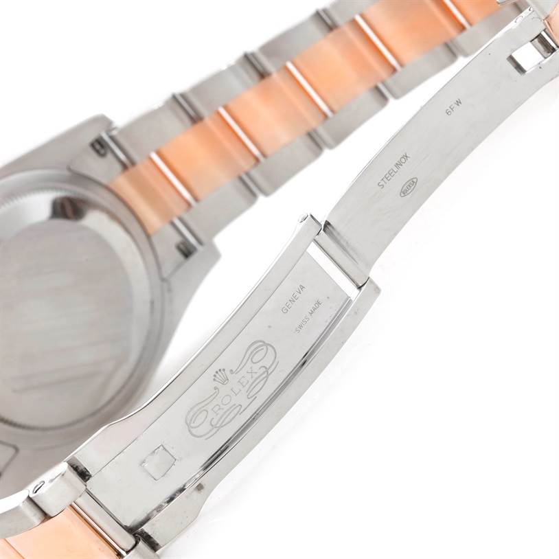 The image shows the open clasp and partial bracelet of a Rolex Datejust 116231 Men's Steel and Gold (two tone) Pink Dial 116231 Men's Steel and Gold (two tone) Pink Dial watch, highlighting its two-tone metal links.