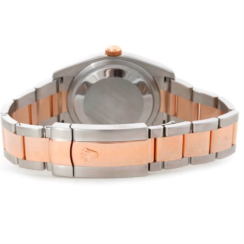 This image of a Rolex Datejust 116231 Men's Steel and Gold (two tone) Pink Dial 116231 Men's Steel and Gold (two tone) Pink Dial shows the back of the case and the clasp of the two-tone bracelet.