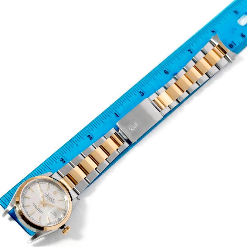 The image shows a Rolex Datejust 16203 Men's Steel and Gold (two tone) Silver Dial 16203 Men's Steel and Gold (two tone) Silver Dial watch laid flat with a two-tone bracelet next to a ruler for measurement.