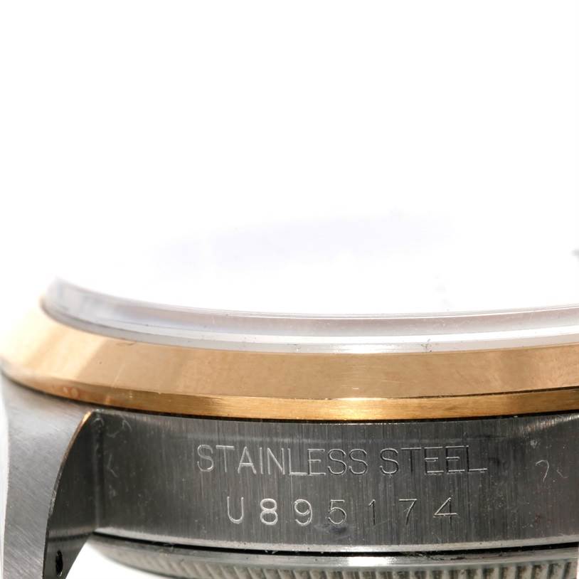 This image shows a close-up of the side of a Rolex Datejust 16203 Men's Steel and Gold (two tone) Silver Dial 16203 Men's Steel and Gold (two tone) Silver Dial watch, highlighting the serial number and stainless steel casing.