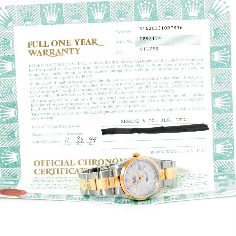 The image shows a Rolex Datejust 16203 Men's Steel and Gold (two tone) Silver Dial 16203 Men's Steel and Gold (two tone) Silver Dial watch resting on its full one-year warranty paper, with the watch face and band visible.