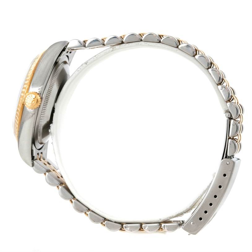 The side view of the Rolex Datejust 16233 Men's Steel and Gold (two tone) Champagne Dial 16233 Men's Steel and Gold (two tone) Champagne Dial watch shows the crown, bezel, and parts of the bracelet.