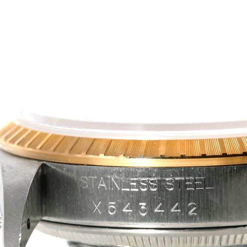 The image shows a close-up side view of the case and bezel of a Rolex Datejust 15223 Men's Steel and Gold (two tone) White Dial 15223 Men's Steel and Gold (two tone) White Dial watch, revealing the stainless steel engraving.