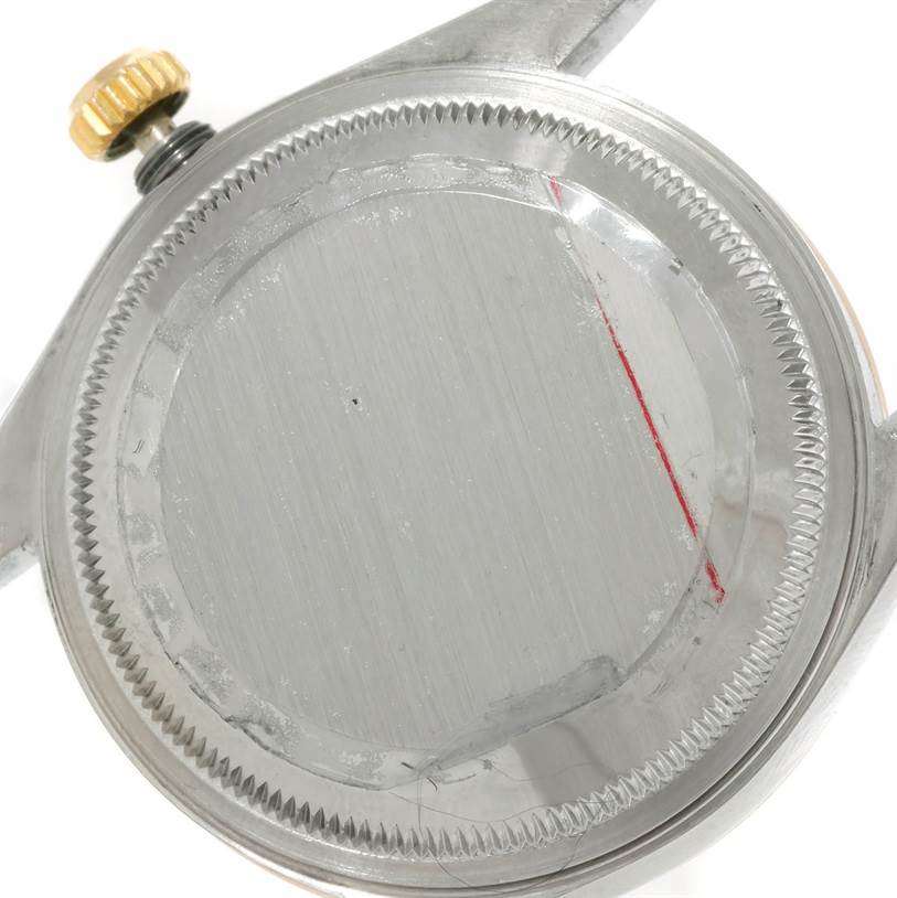 This image shows the back casing and crown of a Rolex Datejust 15223 Men's Steel and Gold (two tone) White Dial 15223 Men's Steel and Gold (two tone) White Dial watch from a top-down angle.