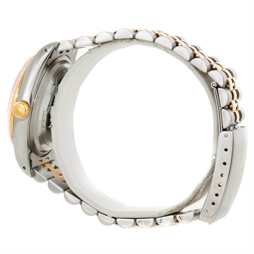 This side view of the Rolex Datejust 15223 Men's Steel and Gold (two tone) White Dial 15223 Men's Steel and Gold (two tone) White Dial watch shows the case, bezel, crown, and Jubilee bracelet.