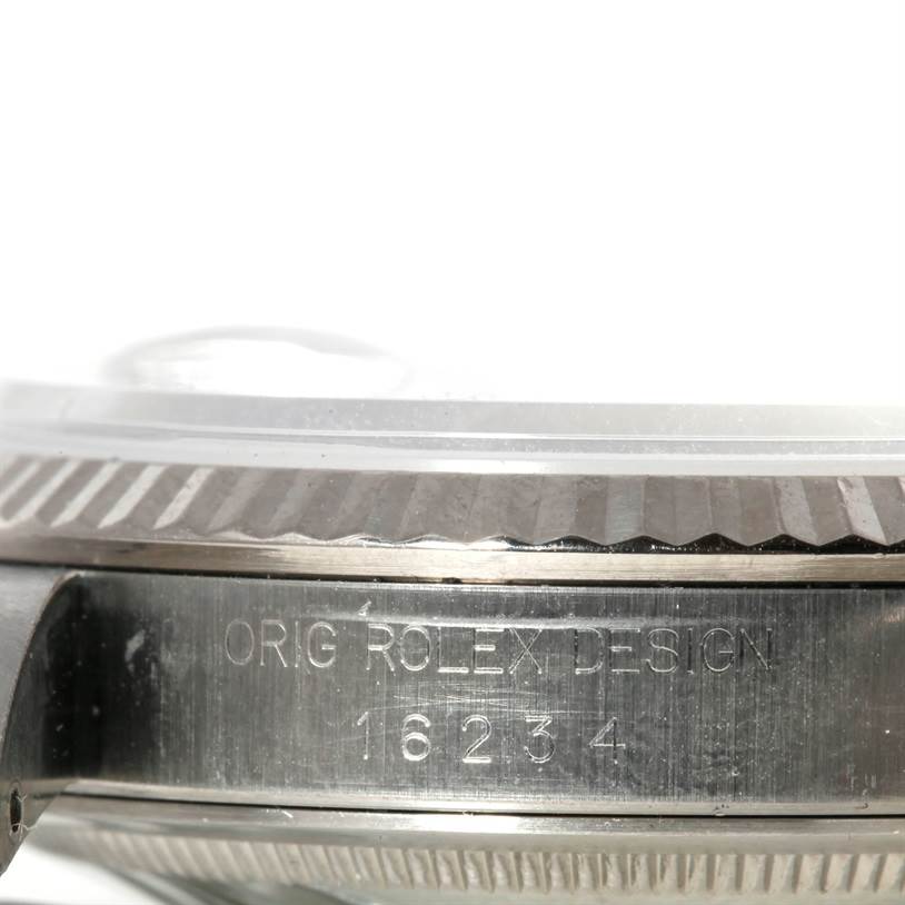 This image shows a close-up side view of the bezel and case of a Rolex Datejust 16234 Men's Stainless Steel Silver Dial 16234 Men's Stainless Steel Silver Dial model, highlighting the "ORIG ROLEX DESIGN 16234" engraving.