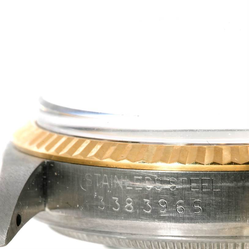 This image shows a close-up of the case and fluted bezel of a Rolex Datejust 1601 Men's Stainless Steel Brown Dial 1601 Men's Stainless Steel Brown Dial watch, displaying the serial number on the stainless steel case.