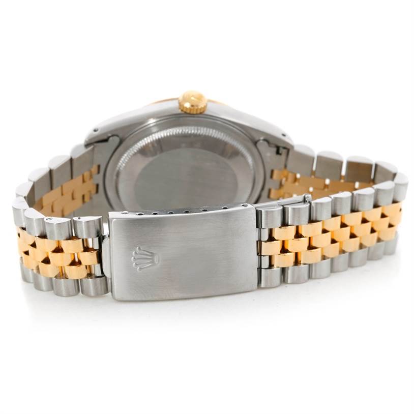 This is the rear view of a Rolex Datejust 16233 Men's Steel and Gold (two tone) Champagne Dial 16233 Men's Steel and Gold (two tone) Champagne Dial watch showcasing the case back and the two-tone Jubilee bracelet with the clasp.