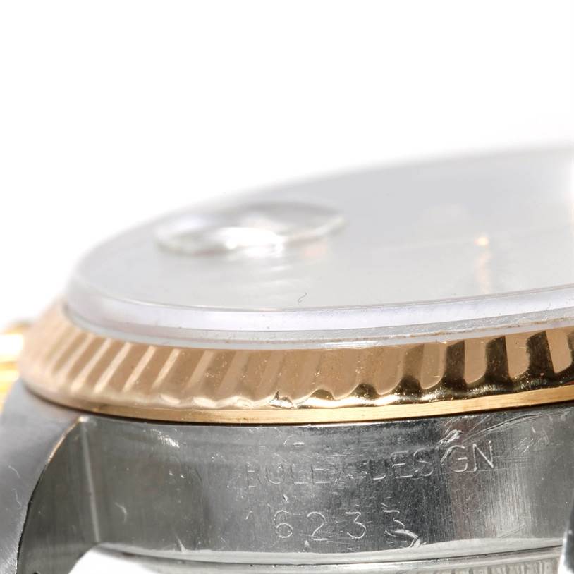 The image shows a close-up side view of a Rolex Datejust 16233 Men's Steel and Gold (two tone) Champagne Dial 16233 Men's Steel and Gold (two tone) Champagne Dial watch featuring the bezel, case, and part of the crystal.