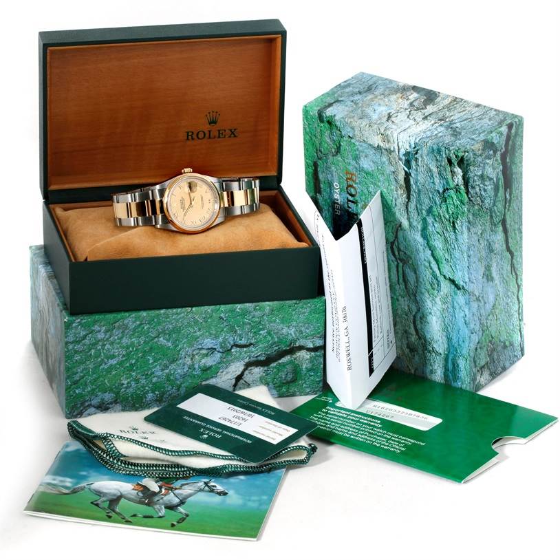 The image shows a Rolex Datejust 16203 Men's Steel and Gold (two tone) Champagne Dial 16203 Men's Steel and Gold (two tone) Champagne Dial watch at an angle inside its open box, with the outer box and accompanying documents and accessories visible.
