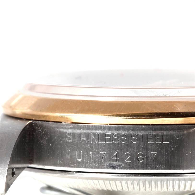 The image shows a close-up, side angle of the Rolex Datejust 16203 Men's Steel and Gold (two tone) Champagne Dial 16203 Men's Steel and Gold (two tone) Champagne Dial watch showing the case, bezel, and part of the serial number.