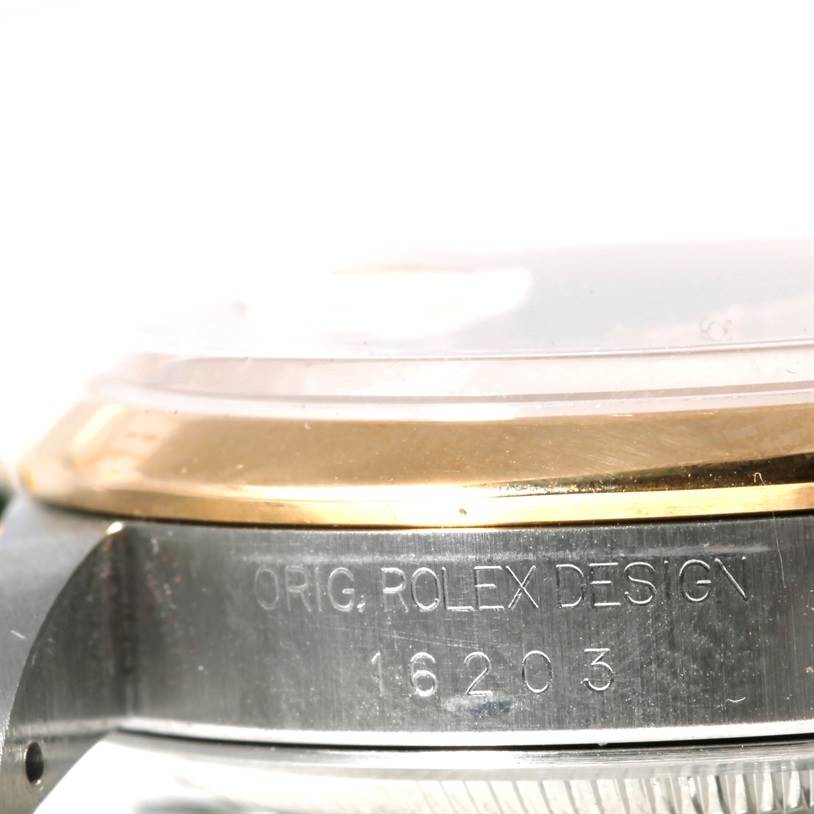 This image shows a side angle view of a Rolex Datejust 16203 Men's Steel and Gold (two tone) Champagne Dial 16203 Men's Steel and Gold (two tone) Champagne Dial watch, highlighting the case side with "ORIG. ROLEX DESIGN 16203" engraving.