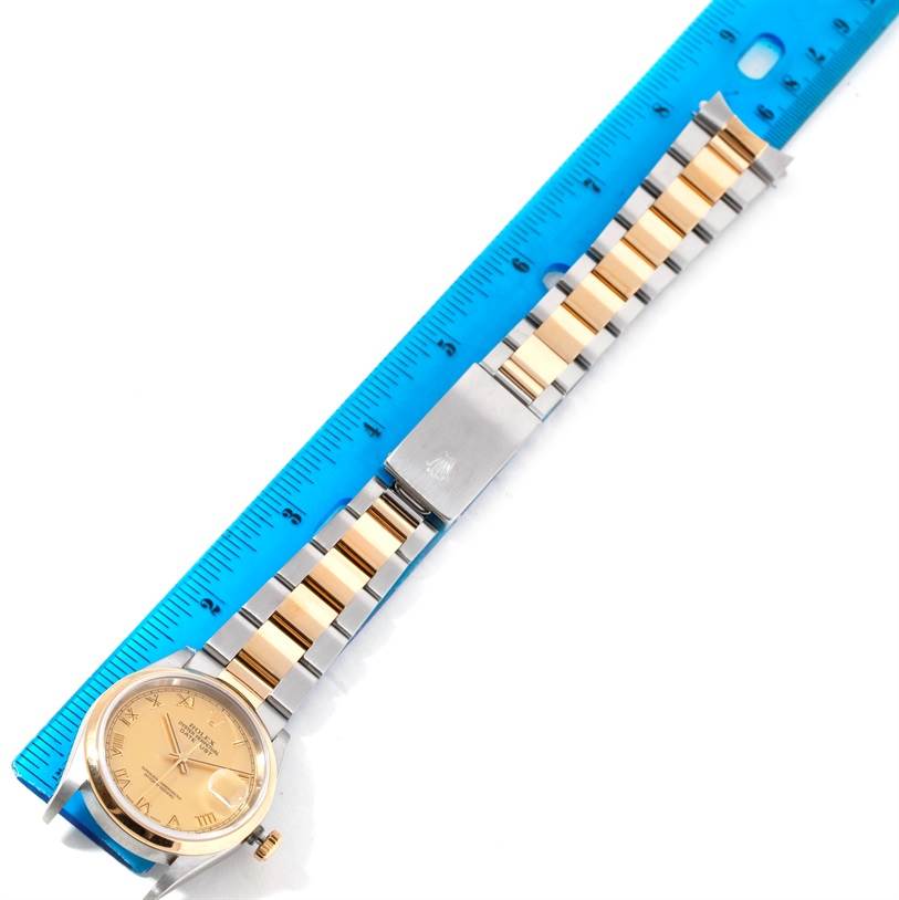 The image shows a Rolex Datejust 16203 Men's Steel and Gold (two tone) Champagne Dial 16203 Men's Steel and Gold (two tone) Champagne Dial watch with a focus on the face, bracelet, and clasp, measured against a blue ruler.