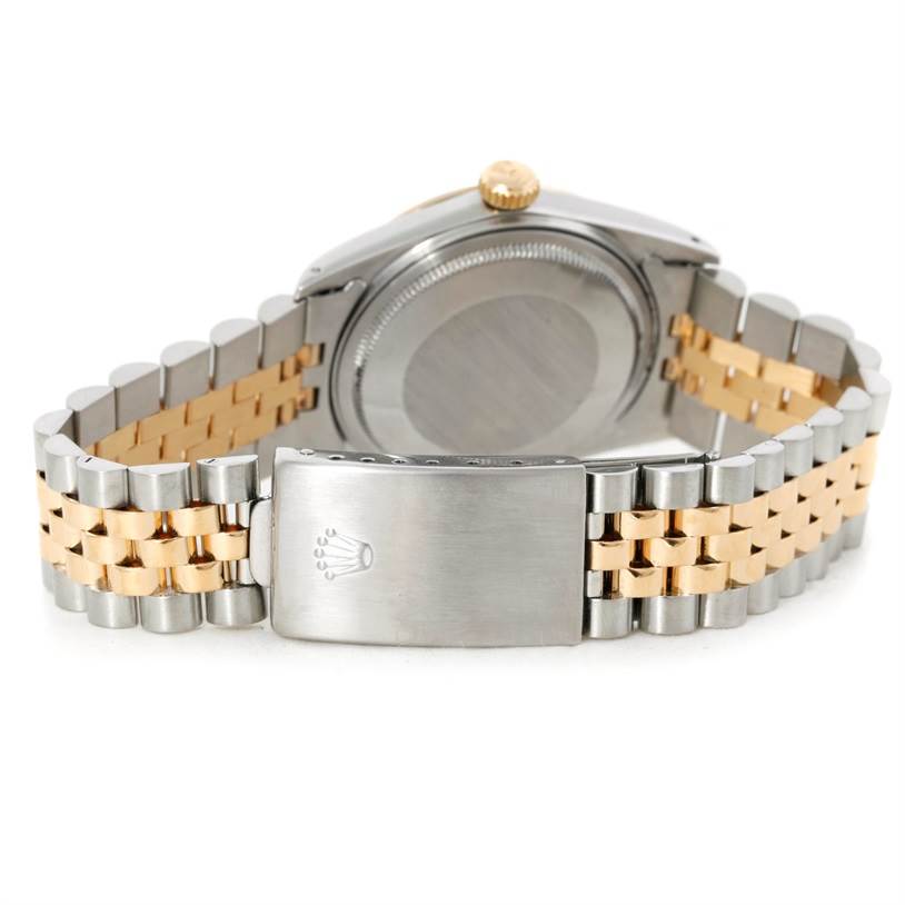 This is a rear view of a Rolex Datejust 16013 Men's Stainless Steel Champagne Dial 16013 Men's Stainless Steel Champagne Dial, showing the bracelet, clasp with logo, and watch case back.