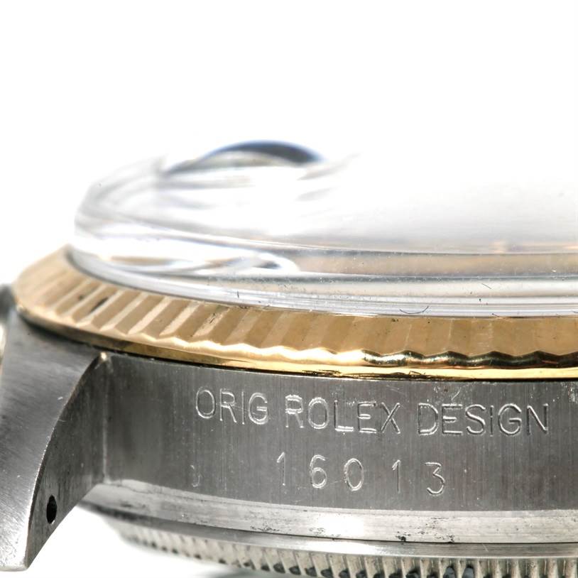 The image shows a close-up side view of the Rolex Datejust 16013 Men's Stainless Steel Champagne Dial 16013 Men's Stainless Steel Champagne Dial watch case, bezel, and part of the glass with engraved text.