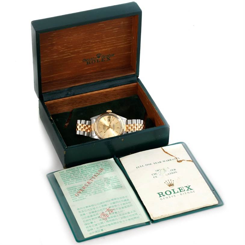 The image shows a Rolex Datejust 16013 Men's Stainless Steel Champagne Dial 16013 Men's Stainless Steel Champagne Dial watch in an open wooden box with accompanying booklets placed in front.