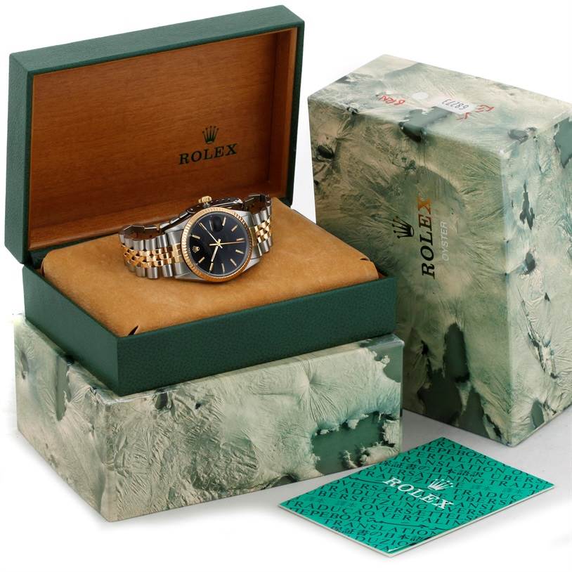 The image shows a Rolex Datejust 16013 Men's Stainless Steel Black Dial 16013 Men's Stainless Steel Black Dial watch at a slight angle within its green and wooden presentation box, along with the outer packaging and documentation.