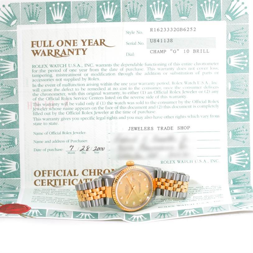The image shows a Rolex Datejust 16233 Men's Steel and Gold (two tone) Champagne Dial 16233 Men's Steel and Gold (two tone) Champagne Dial watch placed on its warranty card, photographed from the top.