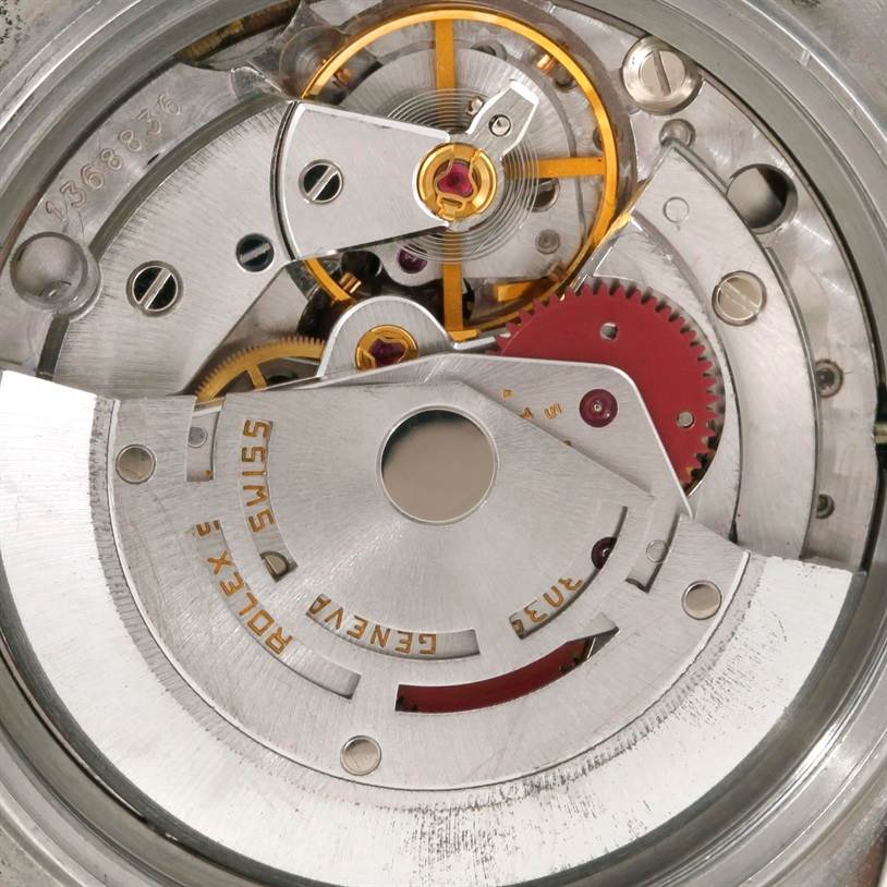 This image shows a close-up view of the movement mechanism of a Rolex Datejust 16013 Men's Stainless Steel Silver Dial 16013 Men's Stainless Steel Silver Dial watch, highlighting gears and the rotor.