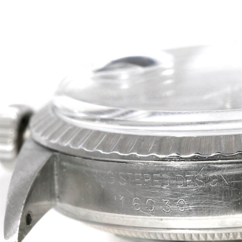 This image shows a close-up side view of the case and bezel of a Rolex Datejust 16030 Men
s Stainless Steel Grey Dial 16030 Men
s Stainless Steel Grey Dial model, including the crown and part of the crystal.